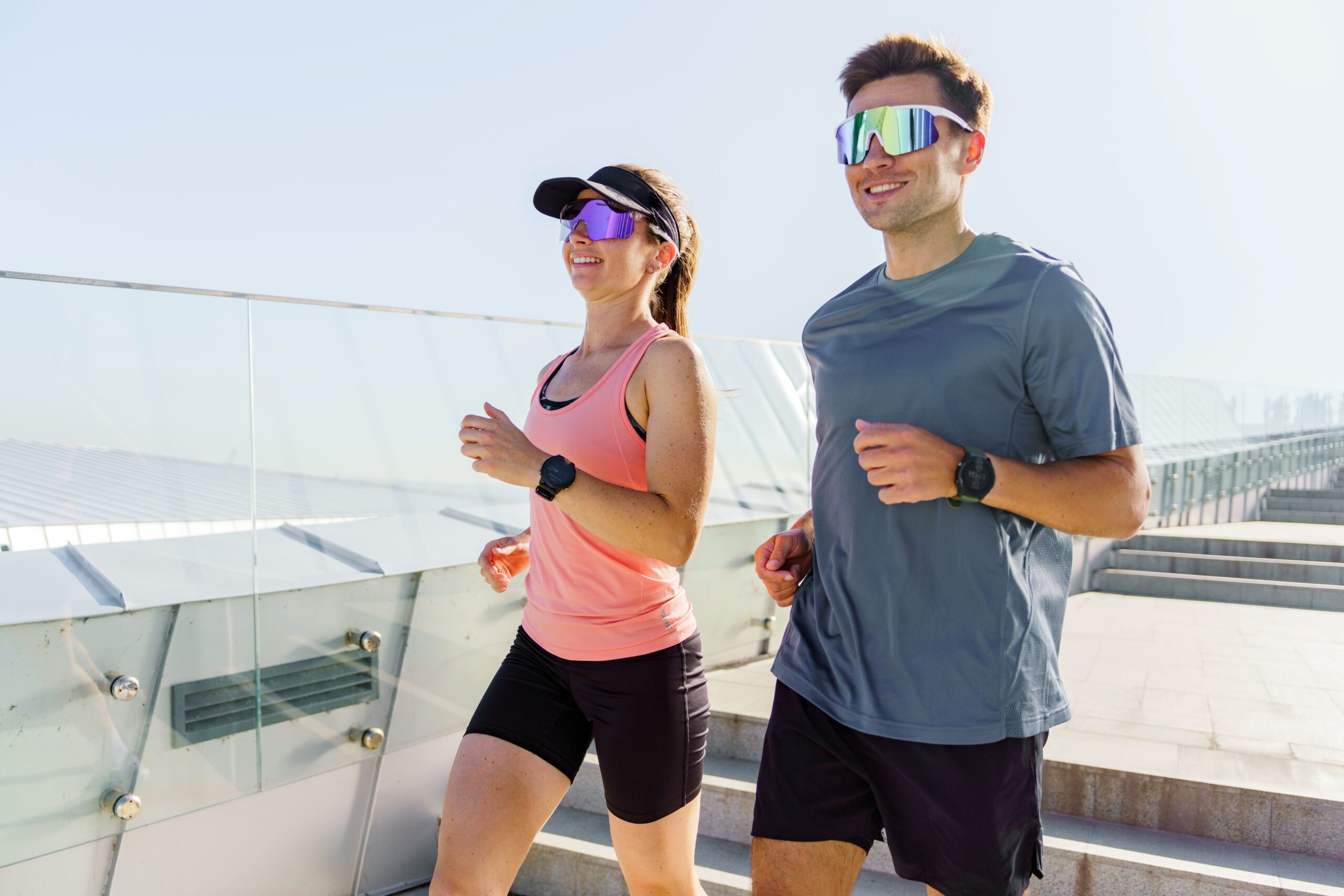 A,Man,And,Woman,Jogging,Side,By,Side,In,Modern